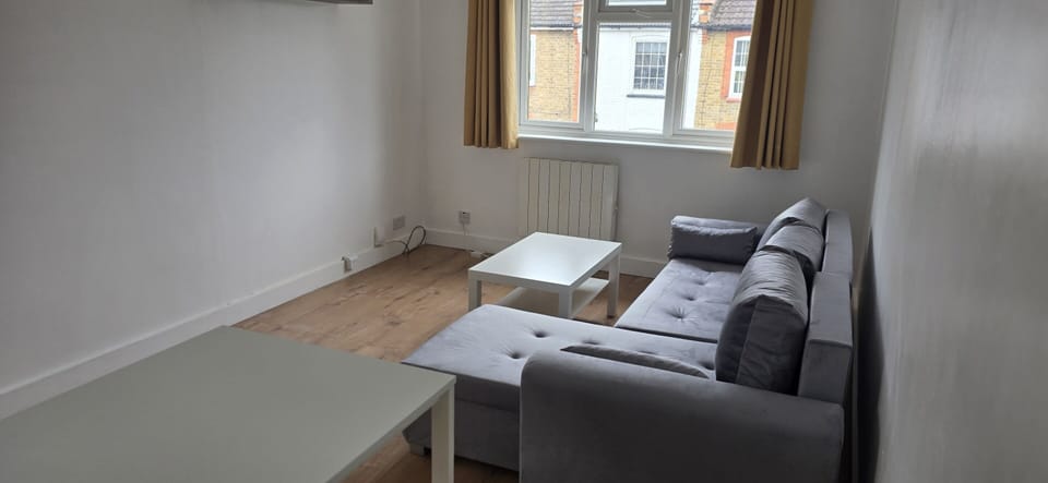 Comfortable living area with sofa seating and TV