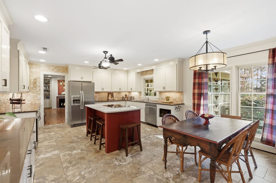Spacious kitchen with island seating, breakfast table, and beautiful cabinetry