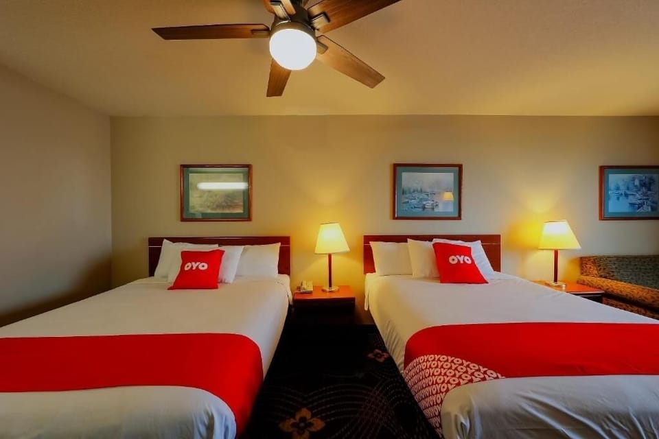 Drift off easily in crisp linens under warm bedside glow.