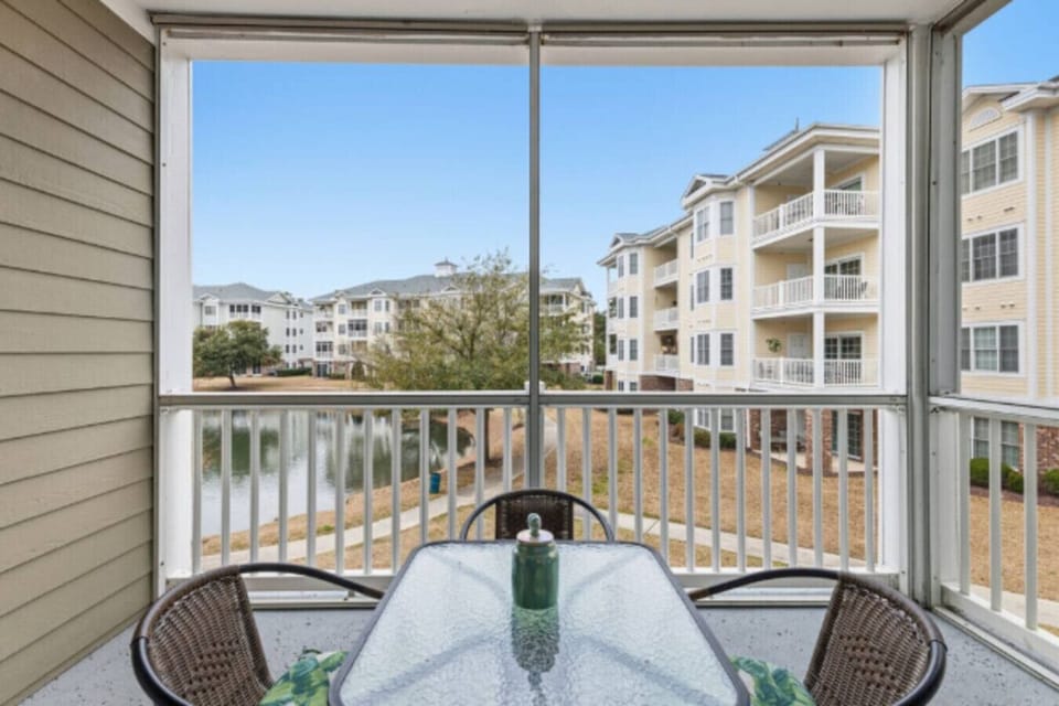 Start your mornings and end your evenings on this private screened-in balcony overlooking the peaceful lake and beautifully maintained grounds. Sip your coffee as the sun rises, enjoy a meal in the fresh coastal air, or unwind with a drink while taking in