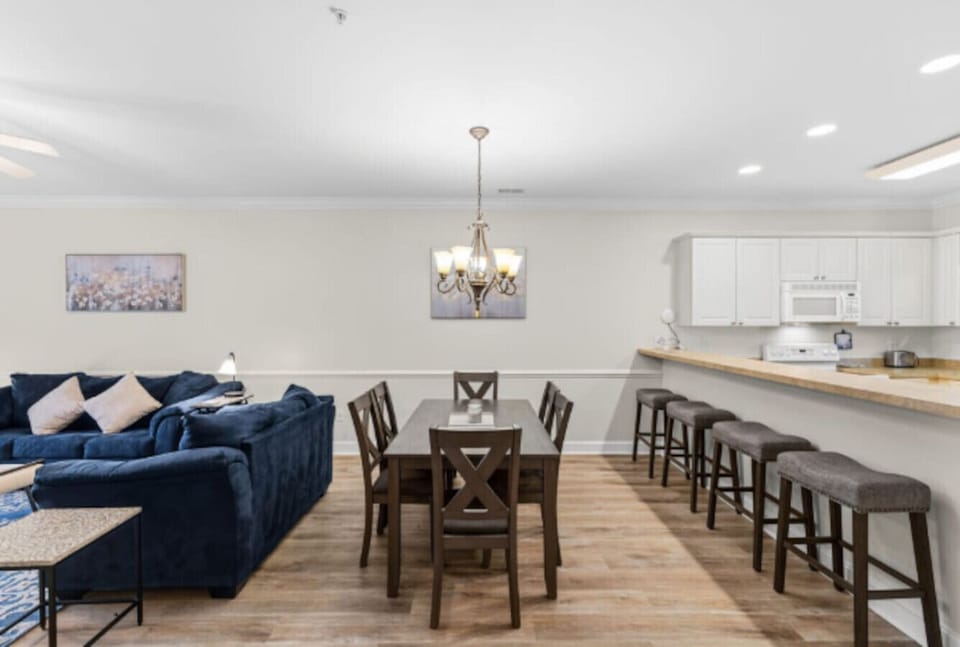 Bring everyone together in this spacious open-concept dining and kitchen area, designed for memorable meals and easy entertaining. Featuring a large dining table for family dinners, additional bar seating at the oversized breakfast counter, and a fully co