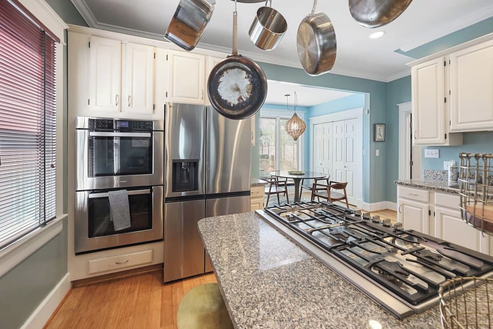 A bathroom and bedroom share a peaceful, airy quality throughout this well-designed home.