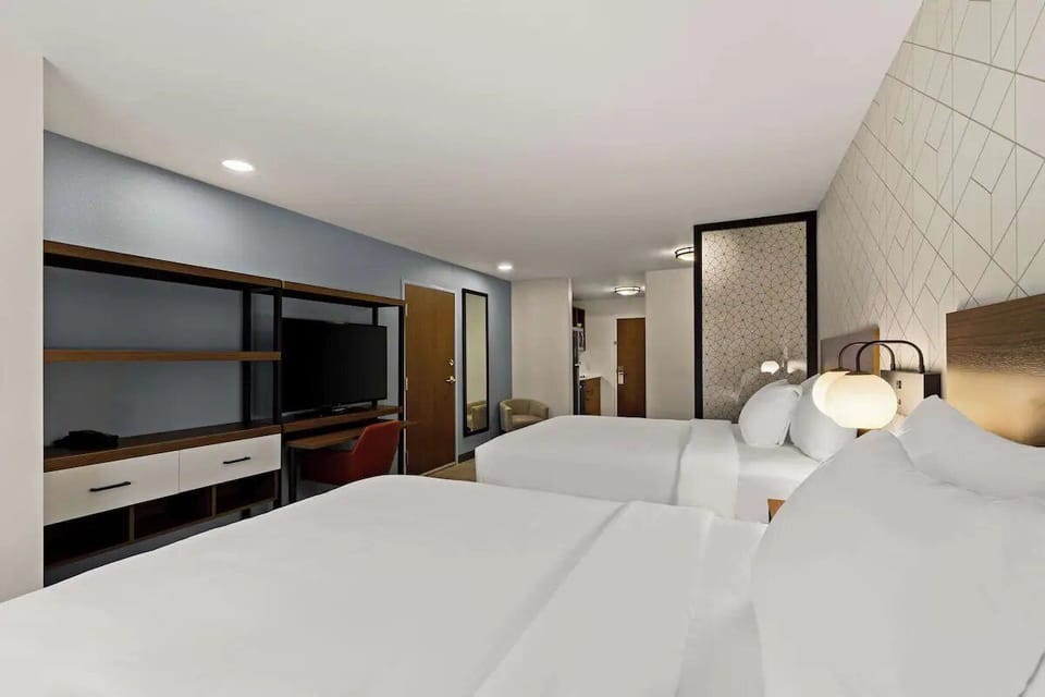 Step into a bright retreat with two beds and workspace.