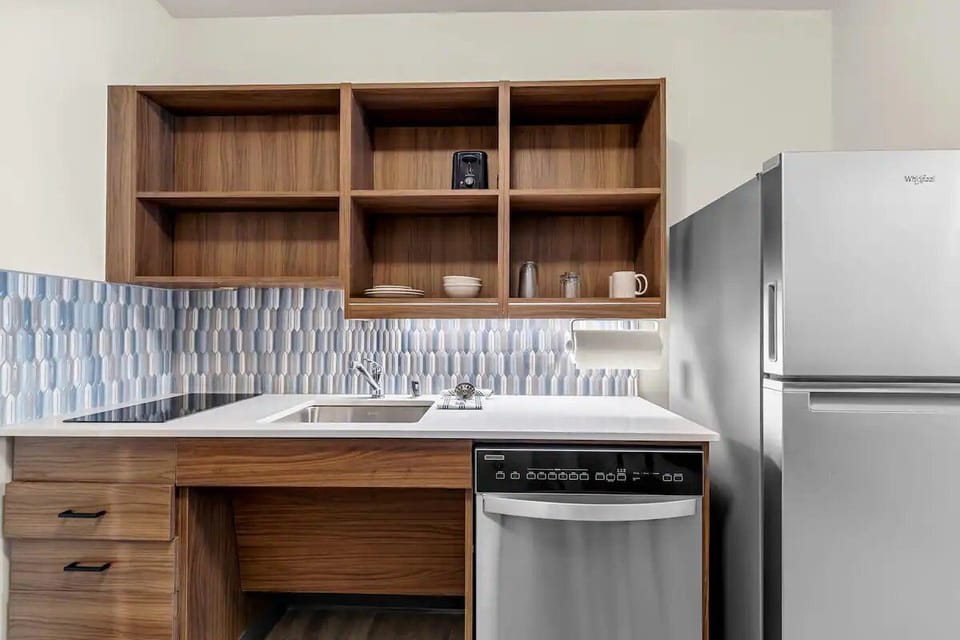 Enjoy easy meals with a sleek kitchenette and full-size fridge.