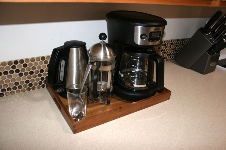 Drip coffee maker, French press, and electric kettle.