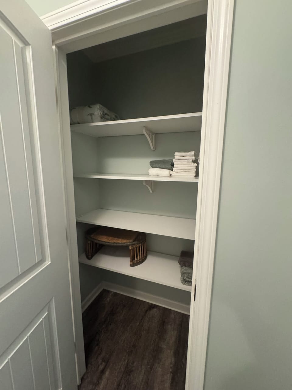Linen closet in hall bathroom. Lots of shelving.