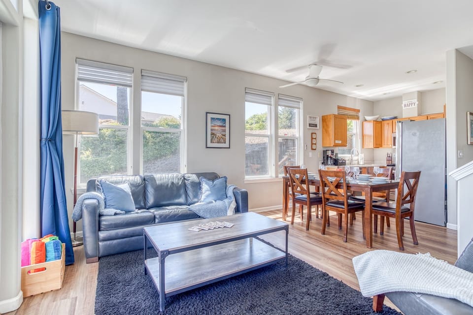 Living Room: Light-filled space with comfy seating, dining for six, and vibrant beach decor!