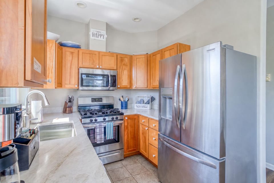 Kitchen: Modern appliances meet beachy vibes in this bright culinary haven! Cook and relax!