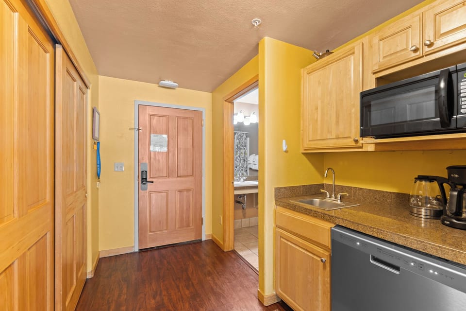 Kitchenette with compact fridge and dishwasher.