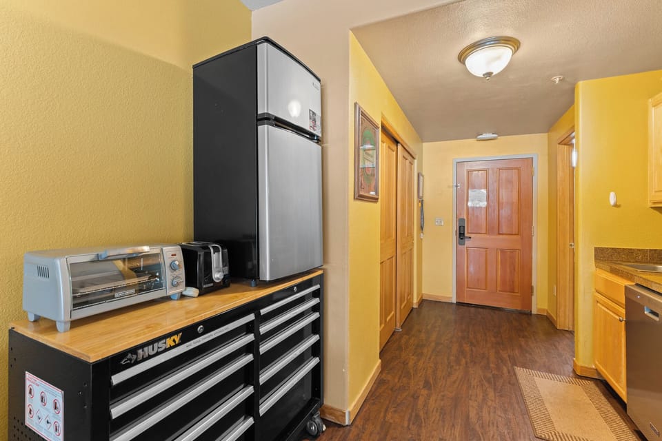 Kitchenette with compact fridge and dishwasher.