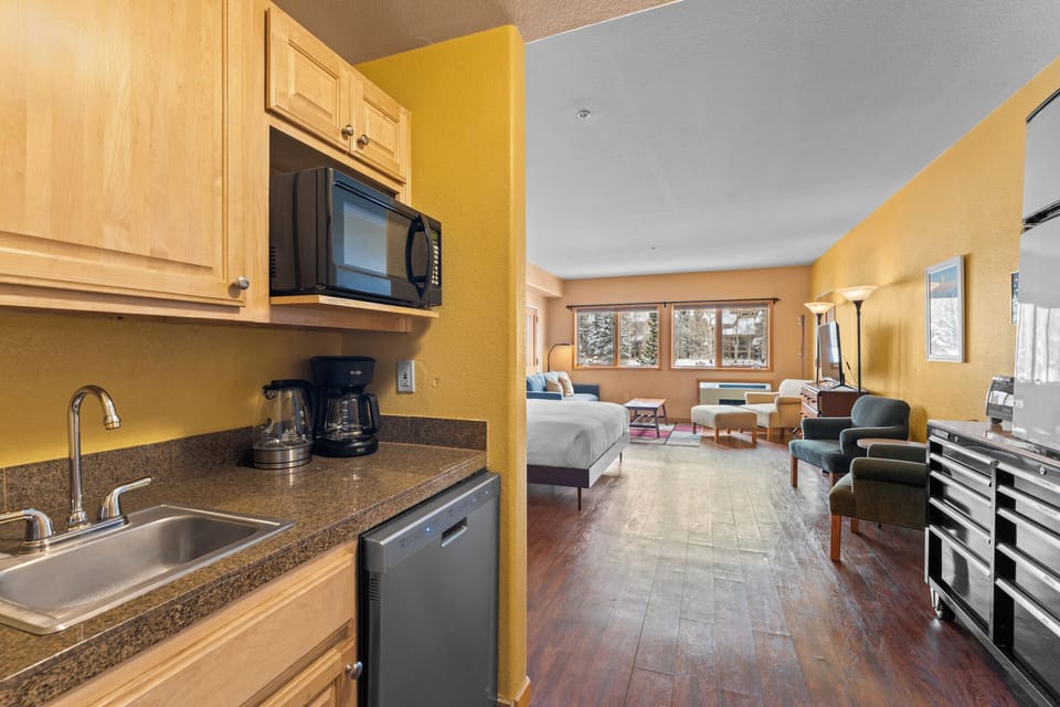 Kitchenette with compact fridge and dishwasher.