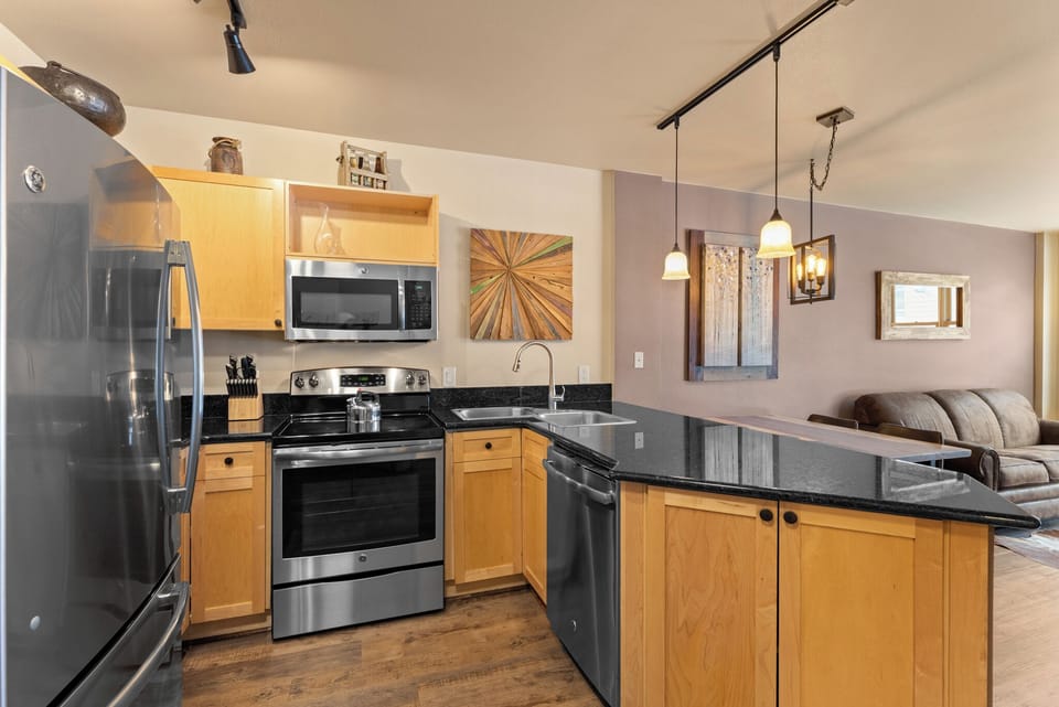 Full kitchen with stainless steel appliances.