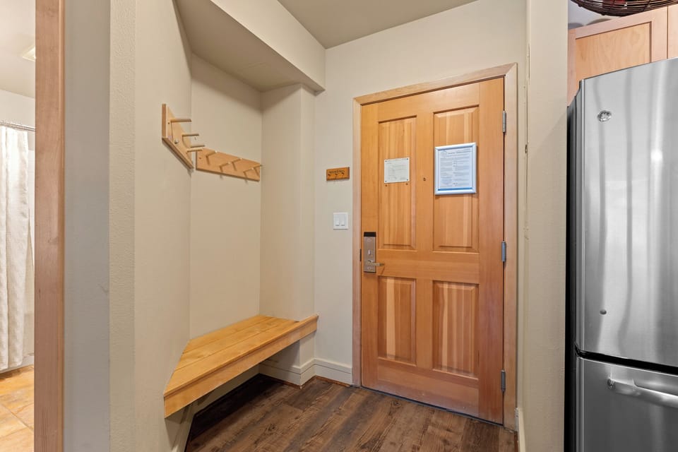 Entryway with a bench and hooks.