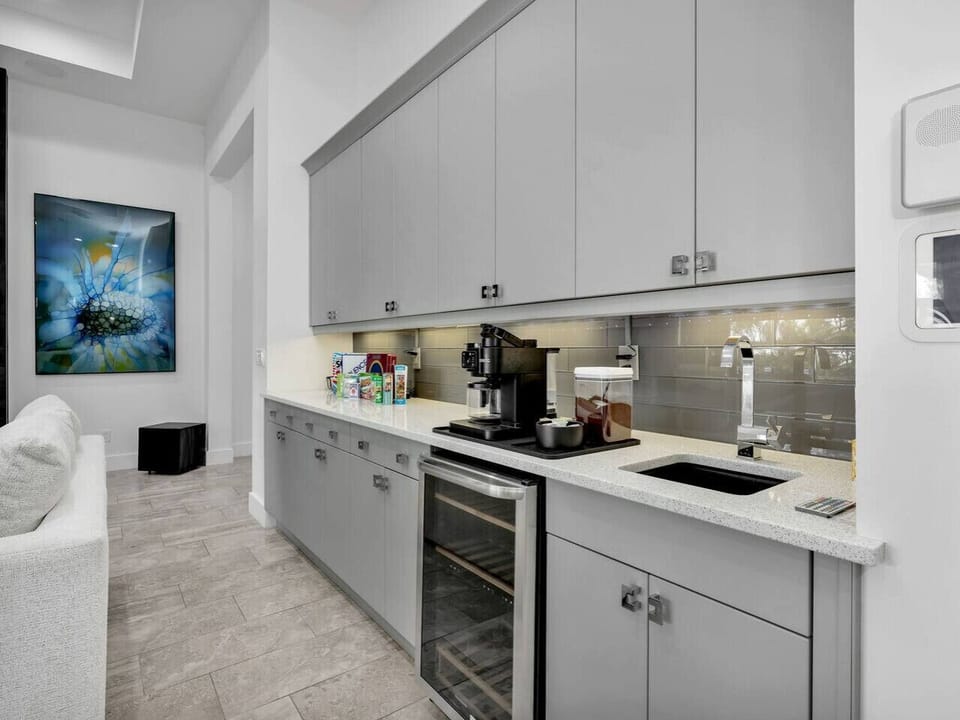 A convenient coffee and beverage station adds extra storage, prep space, and a perfect spot for morning coffee or evening drinks.