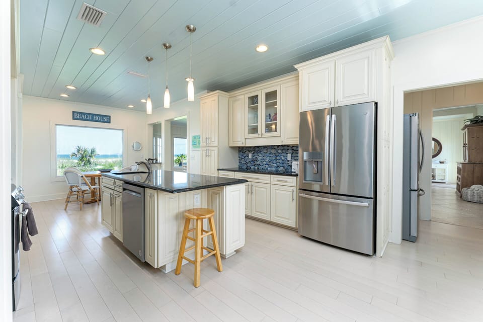Extra fridge adjacent to kitchen and bar area,