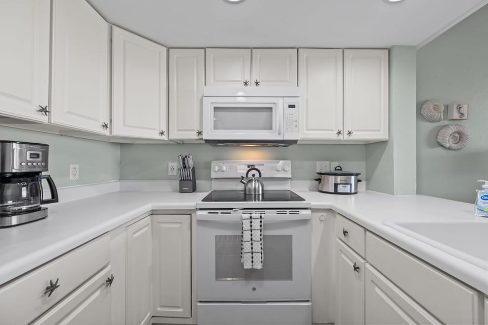 Fully equipped kitchen with coffee maker, crockpot, and all the essentials for easy meals
