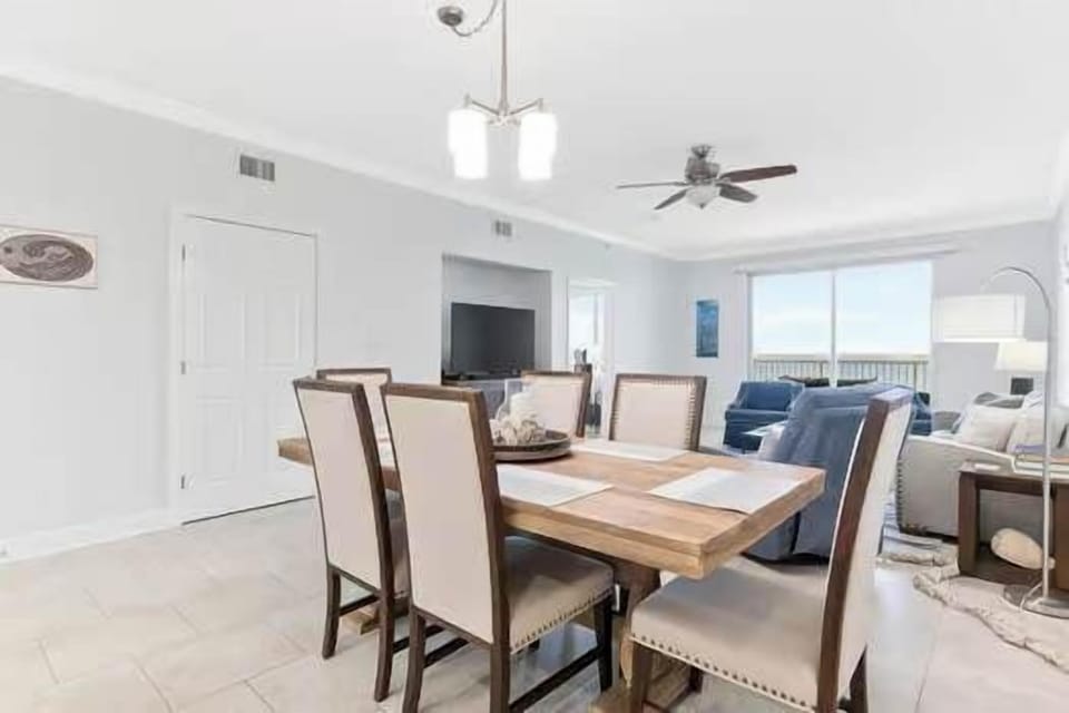 Spacious dining area at Harbour Point 301 featuring a large table with ample seating—perfect for family meals, group gatherings, and enjoying your Perdido Key vacation together.
