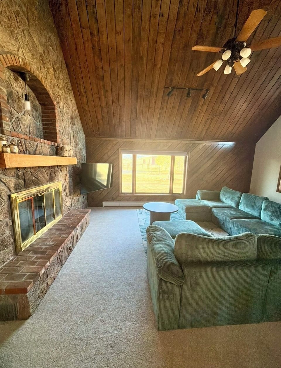 Lounge Room with oversize couch, fireplace, tv & mountain views