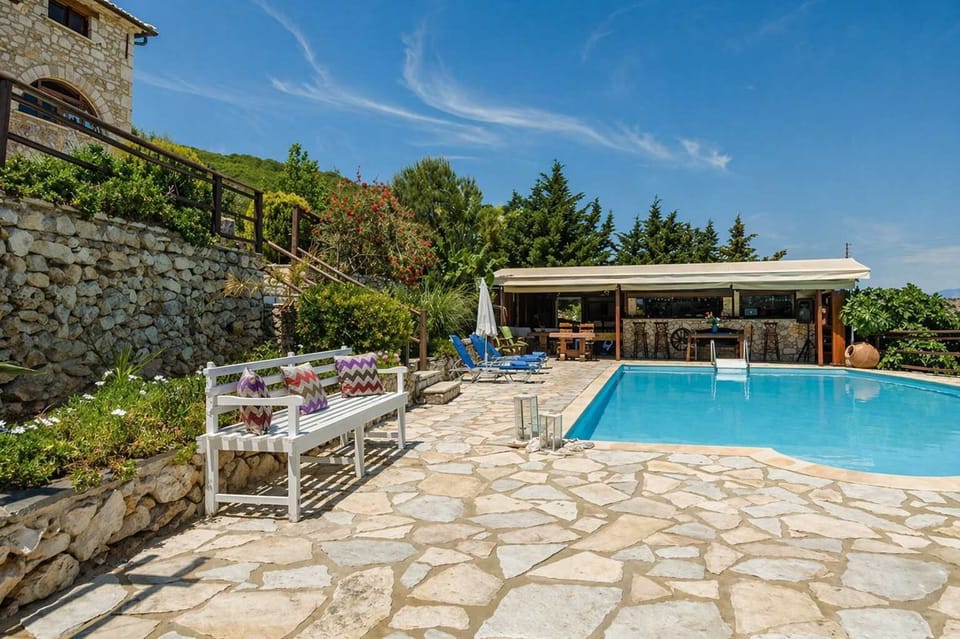 Pool Area with Sunbeds and Stone-Paved Terrace