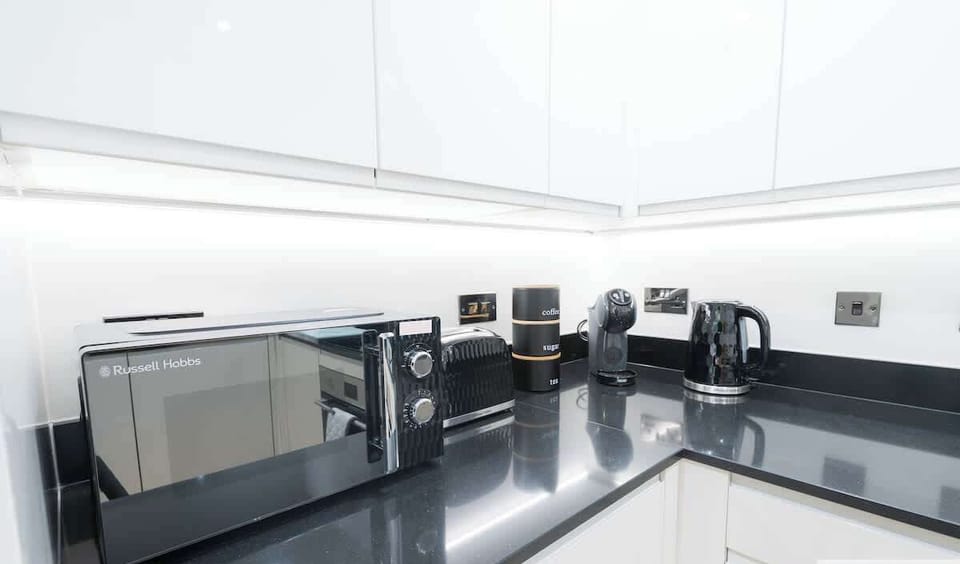 Fully equipped kitchen including microwave, toaster, kettle, & coffee maker (tea bags, coffee, & sugar)