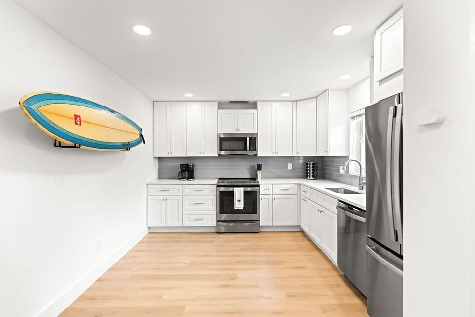 Our modern kitchen design that combines functionality and style! Featuring sleek appliances, ample storage, and a unique surfboard accent for a touch of personality.