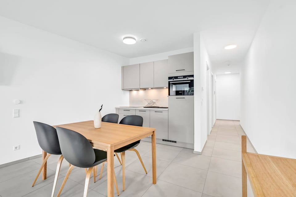 Bright dining area connected to the kitchen, offering a comfortable space for meals and gatherings.