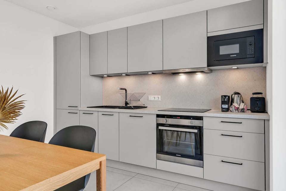Fully equipped kitchen with sleek finishes and everything needed for cooking.