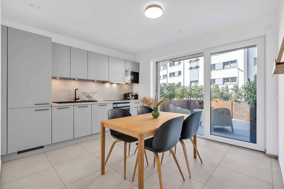 Open kitchen and dining area with modern design and plenty of natural light.