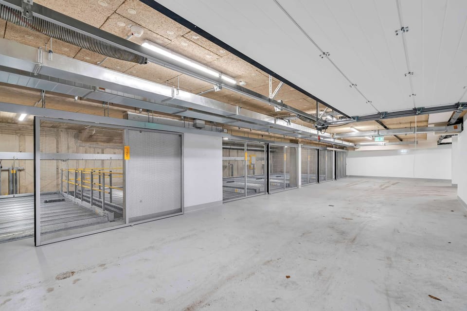 Secure and well-lit garage offering ample parking space 
