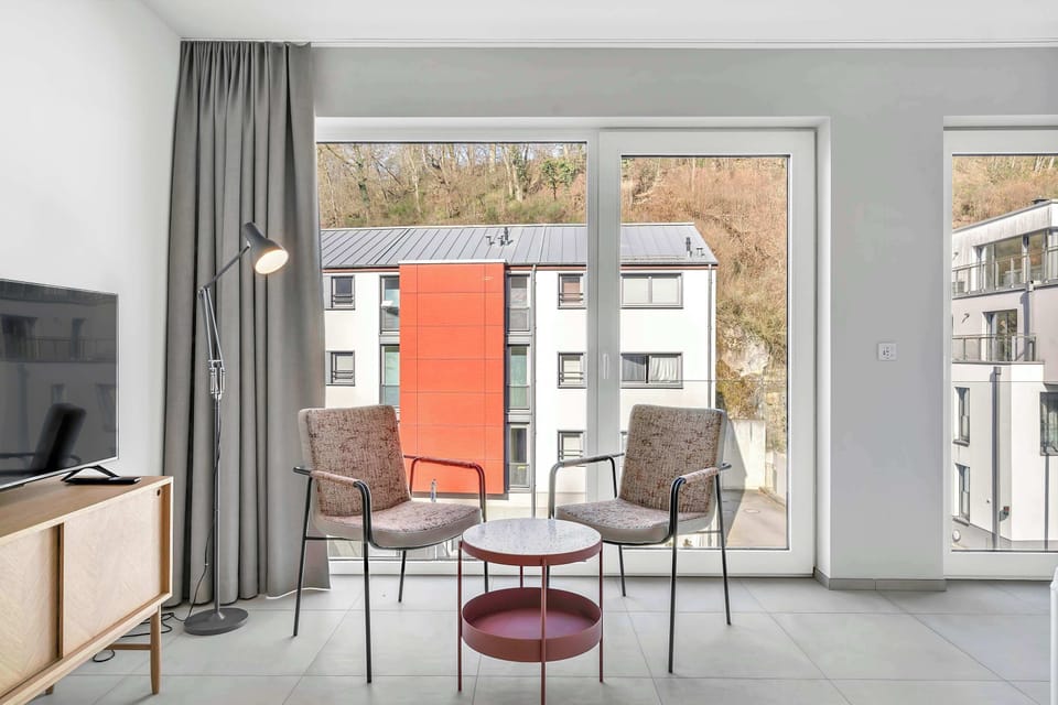 Living area with balcony access, bringing in natural light and outdoor connection.