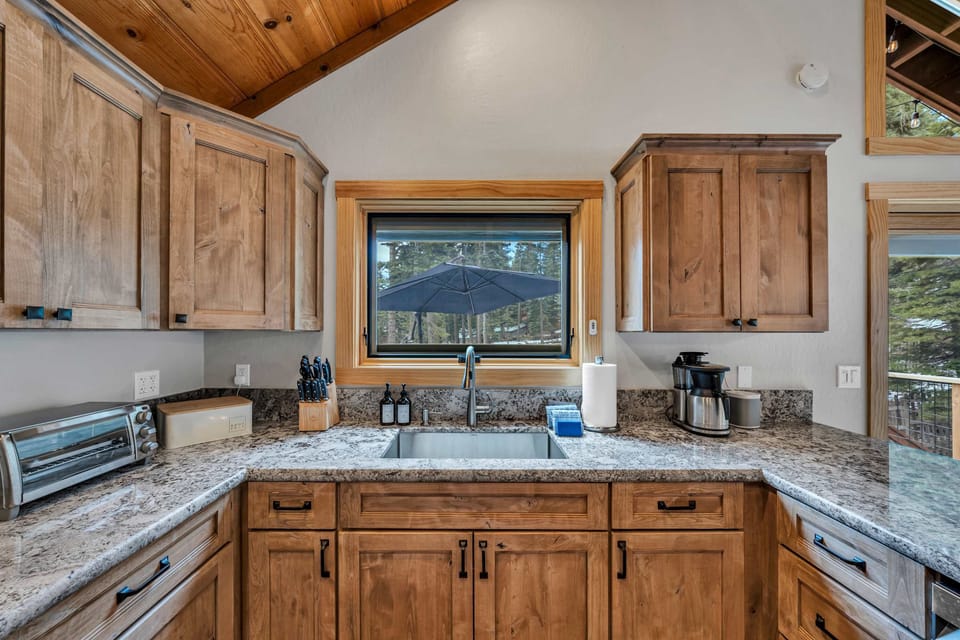 Kitchen: Drip coffee maker, Crockpot, blender, kettle, cooking utensils, tableware, main floor 
