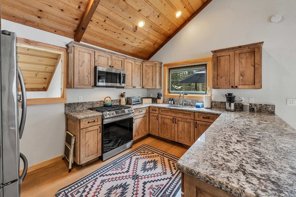 Kitchen: Drip coffee maker, Crockpot, blender, kettle, cooking utensils, tableware, main floor 