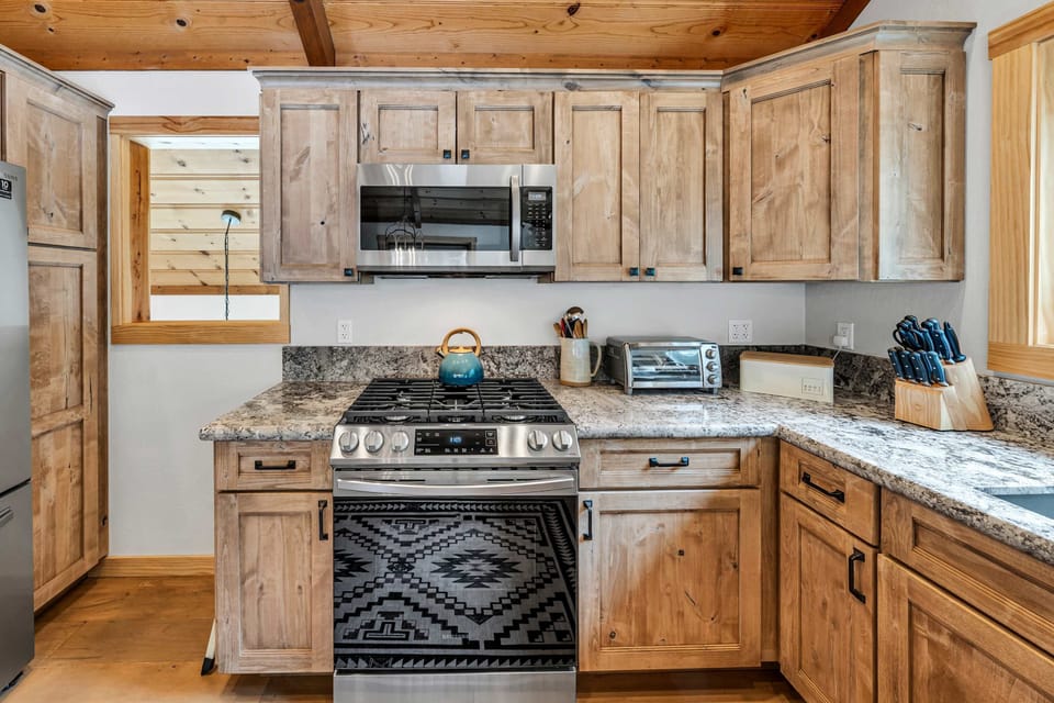 Kitchen: Drip coffee maker, Crockpot, blender, kettle, cooking utensils, tableware, main floor 