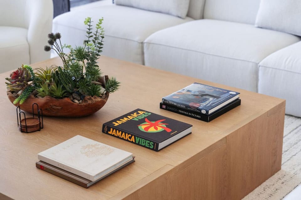Coffee table setup inside a villa, featuring decor and travel-themed books for a luxury, relaxed interior vibe.
