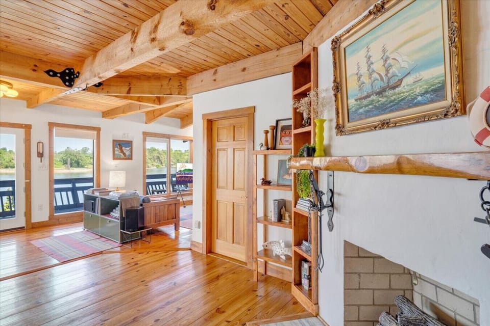 Nearly every room looks out to Smith Mountain Lake, with long views toward Halesford Bridge, expansive shoreline, and an oversized dock.