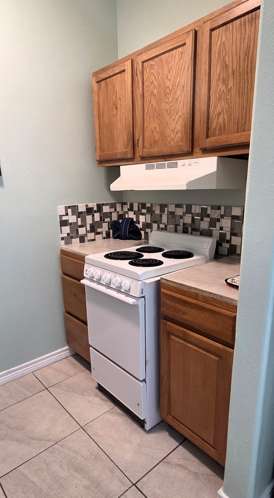 The condo has a full kitchen with a stove/oven, refrigerator, and microwave.