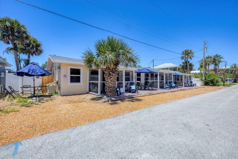 Cozy coastal cottages with screened porches, patio seating, and palms