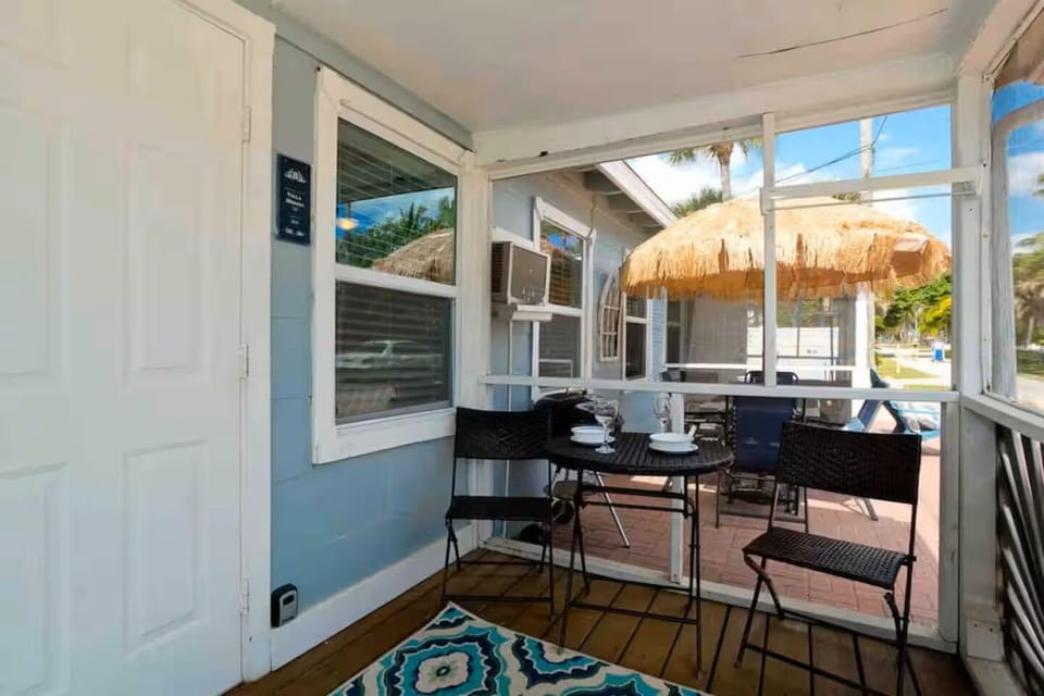 Cozy screened porch and sunny patio with tiki umbrella loungers