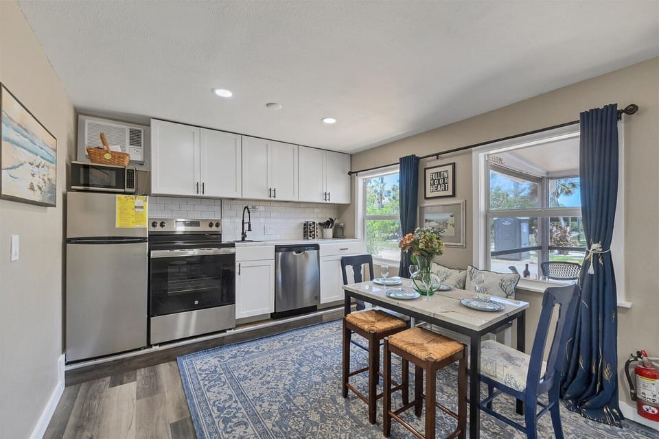 Bright kitchen with stainless appliances and sunny dining nook