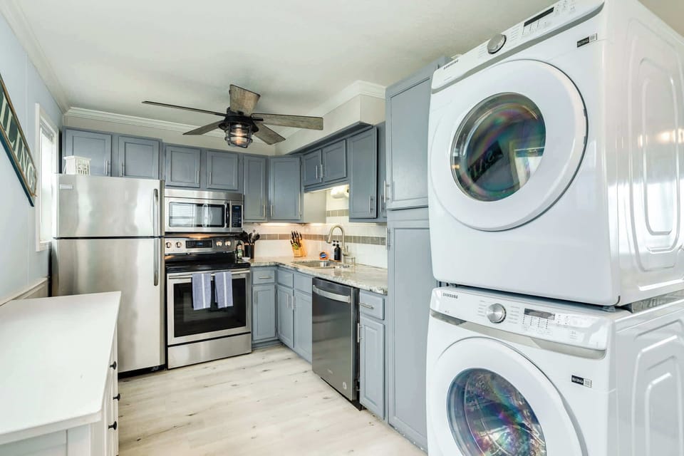 Kitchen with full sized washer and dryer