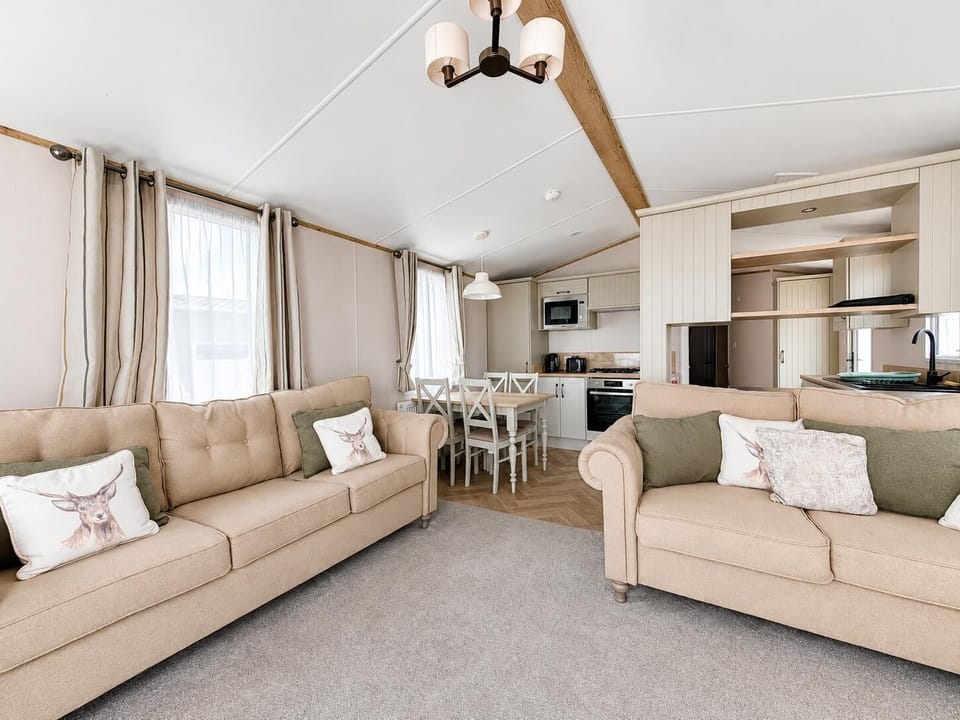 The open plan living room and dining area is perfect for entertaing the family. They will love relaxing on the comfy sofas and catching up on their favourite tv shows whilst dinner is cooking.