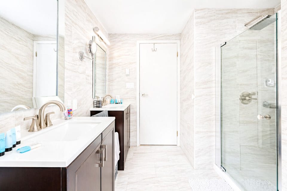 Modern, spacious, and spa-like ✨ Sleek double vanity, large mirrors, and a walk-in shower—perfect for relaxing or getting ready.