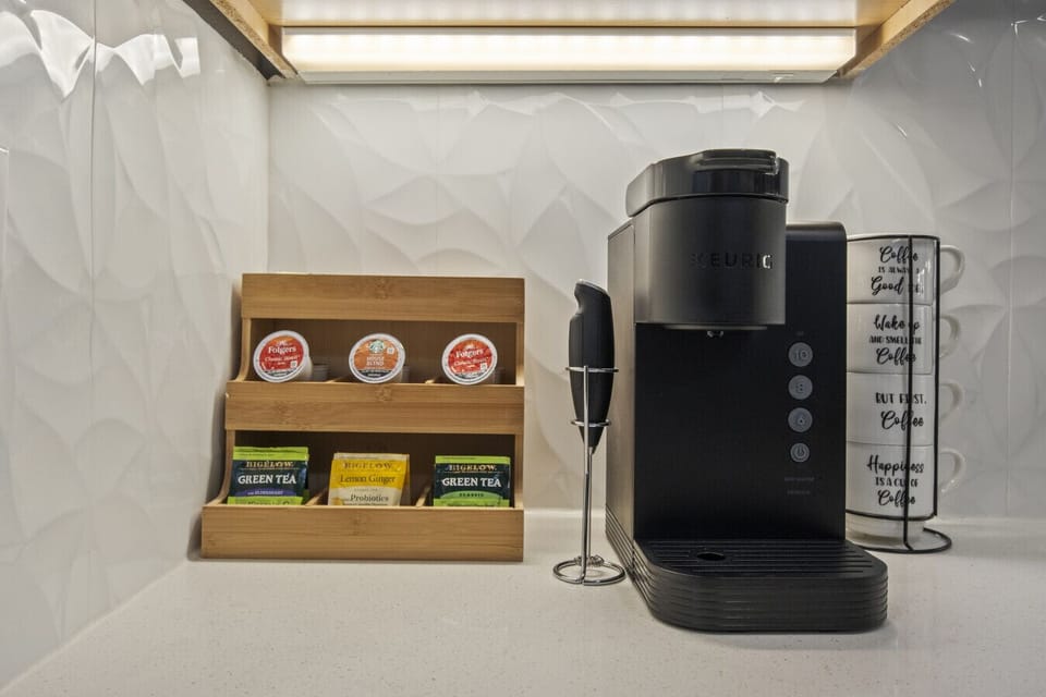 Enjoy a stocked coffee and tea station complete with milk frother, sugar, and cream