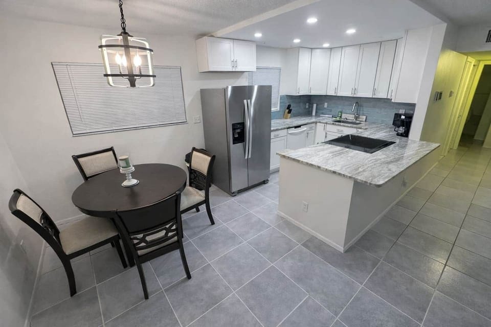 Full kitchen with granite counter tops and Samsung appliances .  Refrigerator has ice and filtered water and the stove has smart capabilities including a built in air fryer. Kitchen is fully stocked with  pots, pans and dishes and wooden dining table