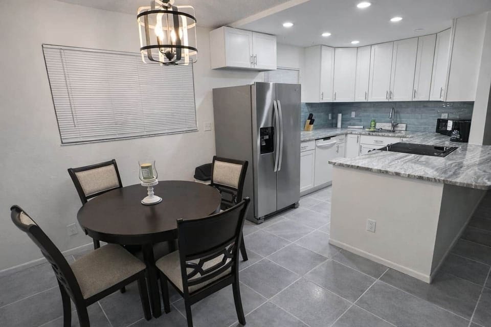 Full kitchen with granite counter tops and Samsung appliances .  Refrigerator has ice and filtered water and the stove has smart capabilities including a built in air fryer. Kitchen is fully stocked with  pots, pans and dishes and wooden dining table