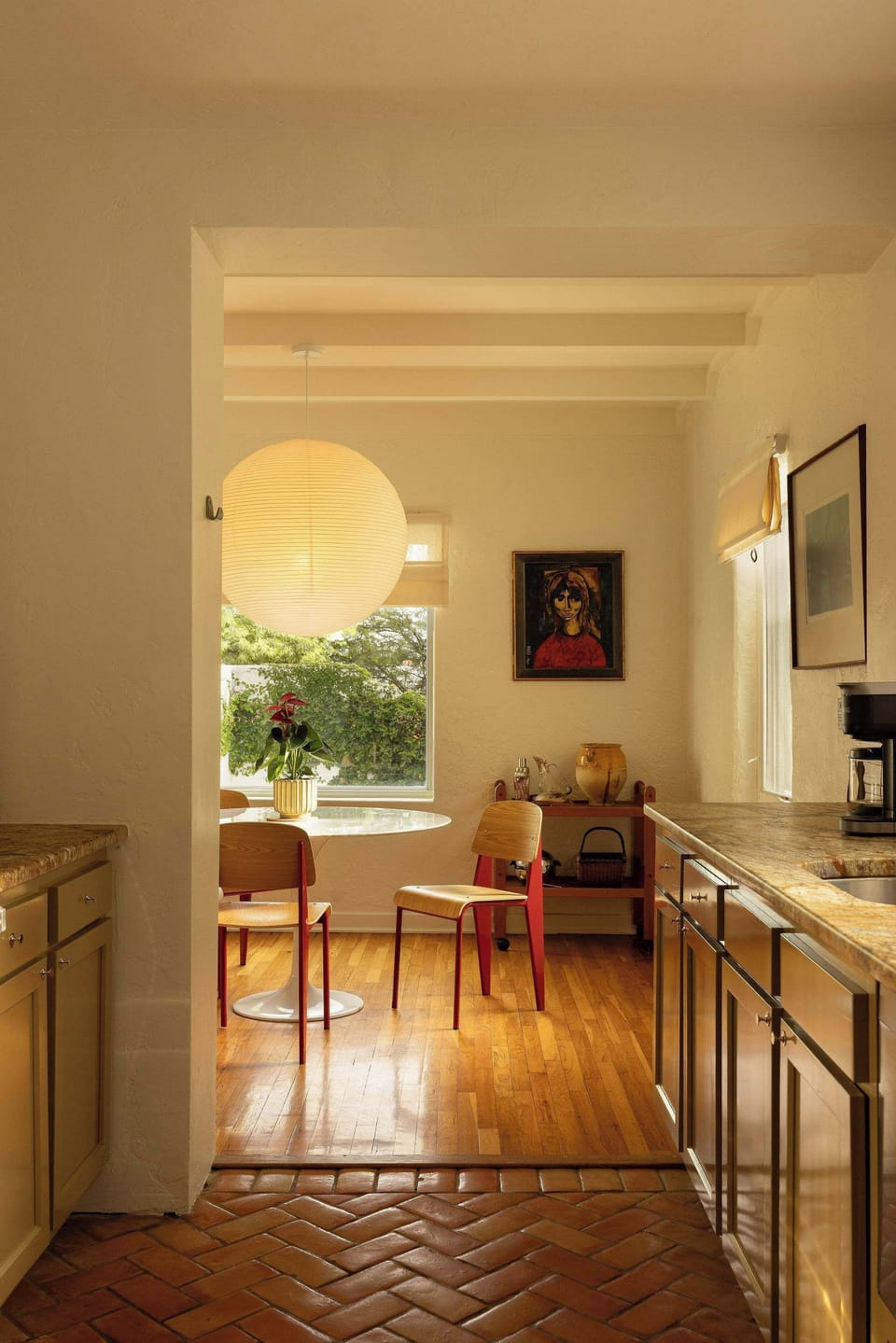 The wide threshold creates a seamless sightline from the kitchen to the dining area.