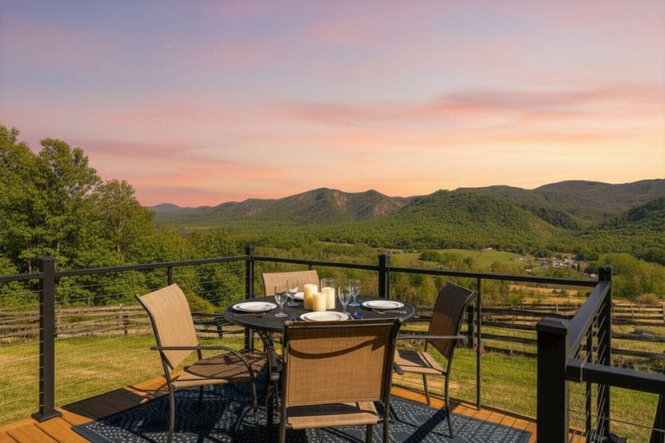 This is a scenic deck with mountain views, an outdoor dining table, and modern cable railings, providing a relaxed spot to take in the surroundings.