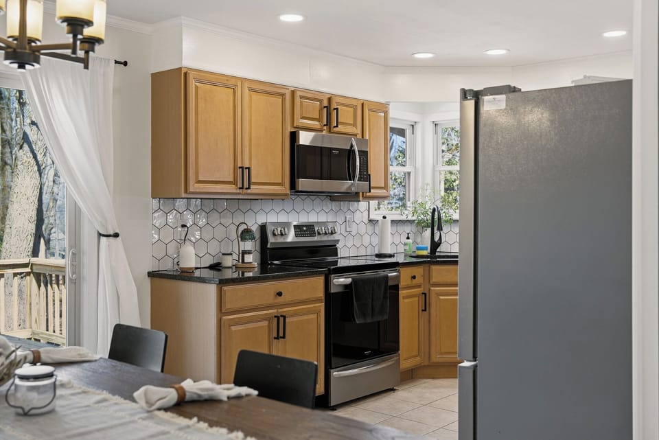 Bright kitchen featuring a classic subway tile backsplash and granite countertops.