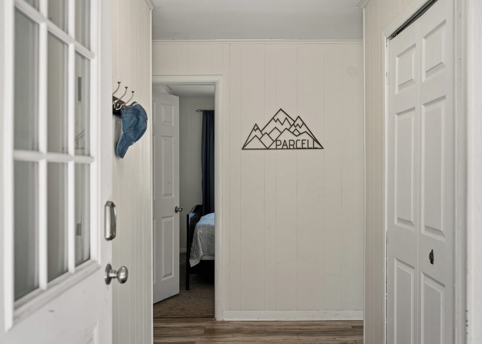 Clean hallways featuring rustic wall art and modern flooring.