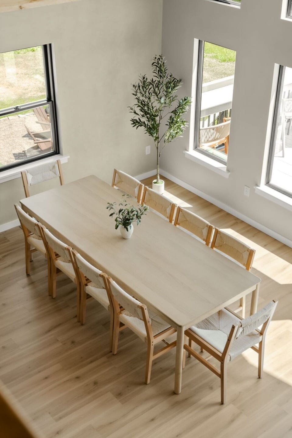 Gather around the spacious dining table, surrounded by natural light and peaceful woodland views